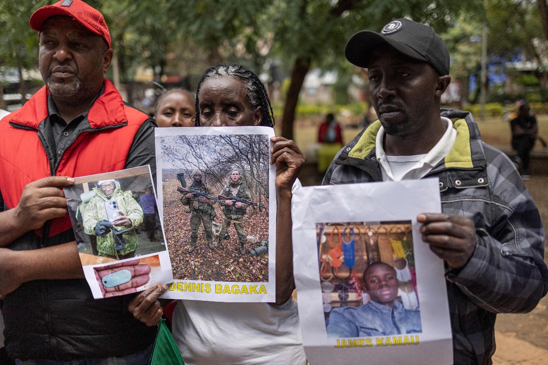 Relatives of Kenyan nationals conscripted by the Russian army in Ukraine pose with photos of their family members during a prayer and peaceful demonstration demanding urgent government action to repatriate their kin, in Nairobi, Kenya. (AFP)