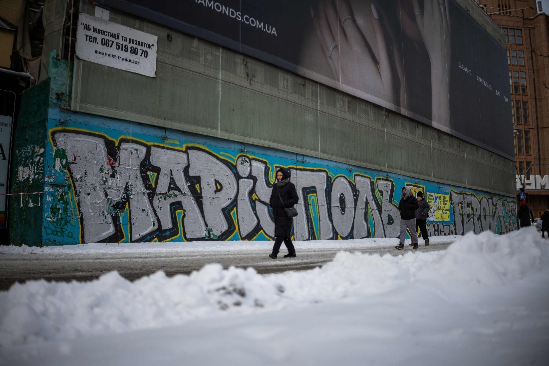 People walk past a mural for Mariupol defenders in central in Kyiv, Ukraine. (AFP)