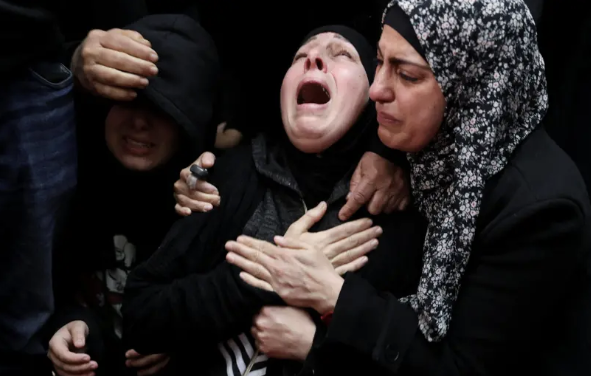 The mother of Nasrallah Abu Siyam, 19, grieves at his funeral on Thursday. His family have demanded accountability, amid mounting scrutiny over a surge in settler violence and a lack of prosecutions. (Reuters)