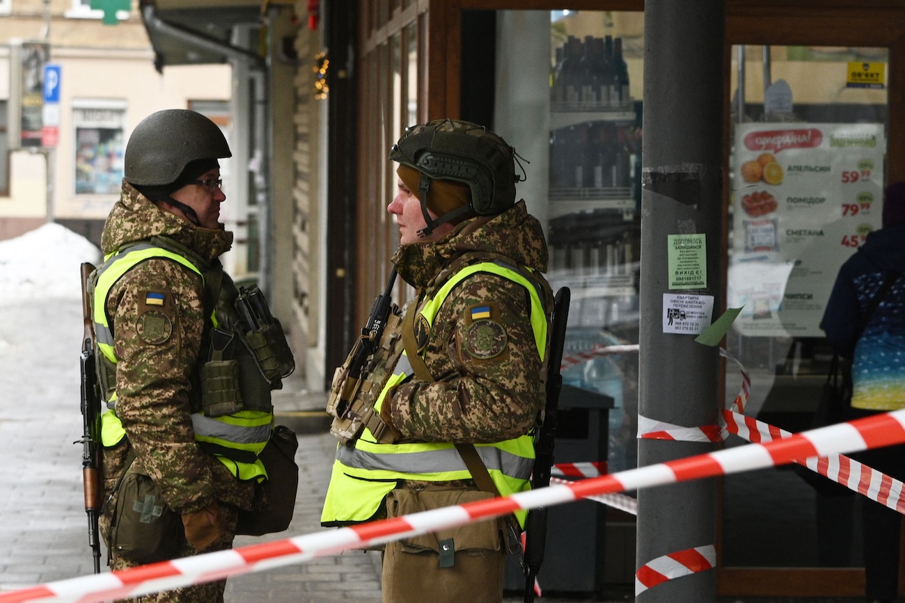 Ukrainian law enforcement officers secure an area at the site of an explosion that rocked a shop in Lviv on February 22, 2026, amid the Russian invasion of Ukraine. (AFP)