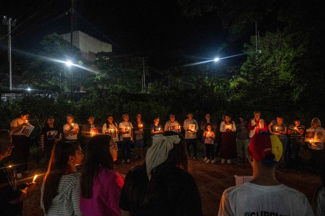 Relatives of political prisoners light candles during a vigil outside after a debate on an amnesty bill proposed by Venezuela’s interim president Delcy Rodriguez, outside El Rodeo I prison in Guatire, Venezuela. (AFP)