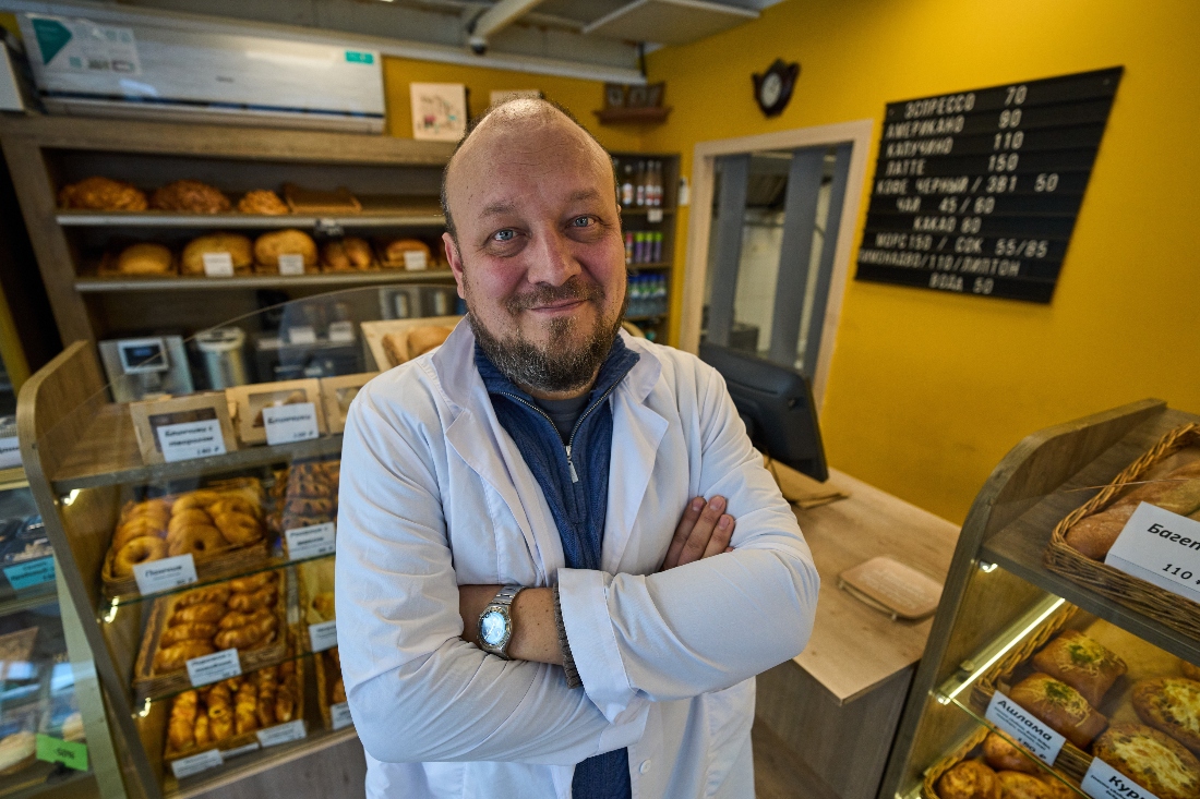 Denis Maksimov poses for a photo in the sales area of his bakery outside Moscow, Russia. (AP)