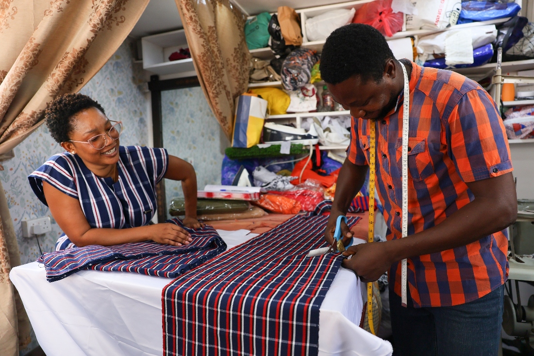 Perfectual Linnan, a fashion designer, interacts with a staff member at her workshop in Accra, Ghana. (AP)