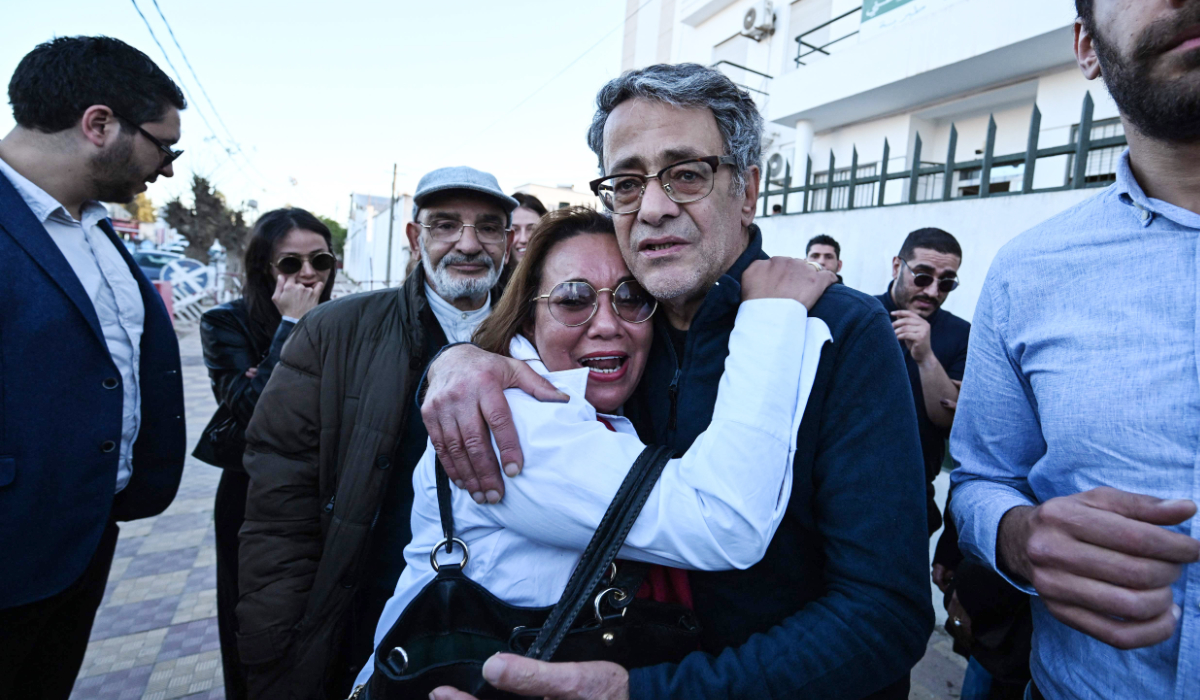 Prominent Tunisian lawyer Ahmed Souab hugs a relative upon his release from prison, outside the National Guard headquarters in Tebourba on February 23, 2026. (AFP)