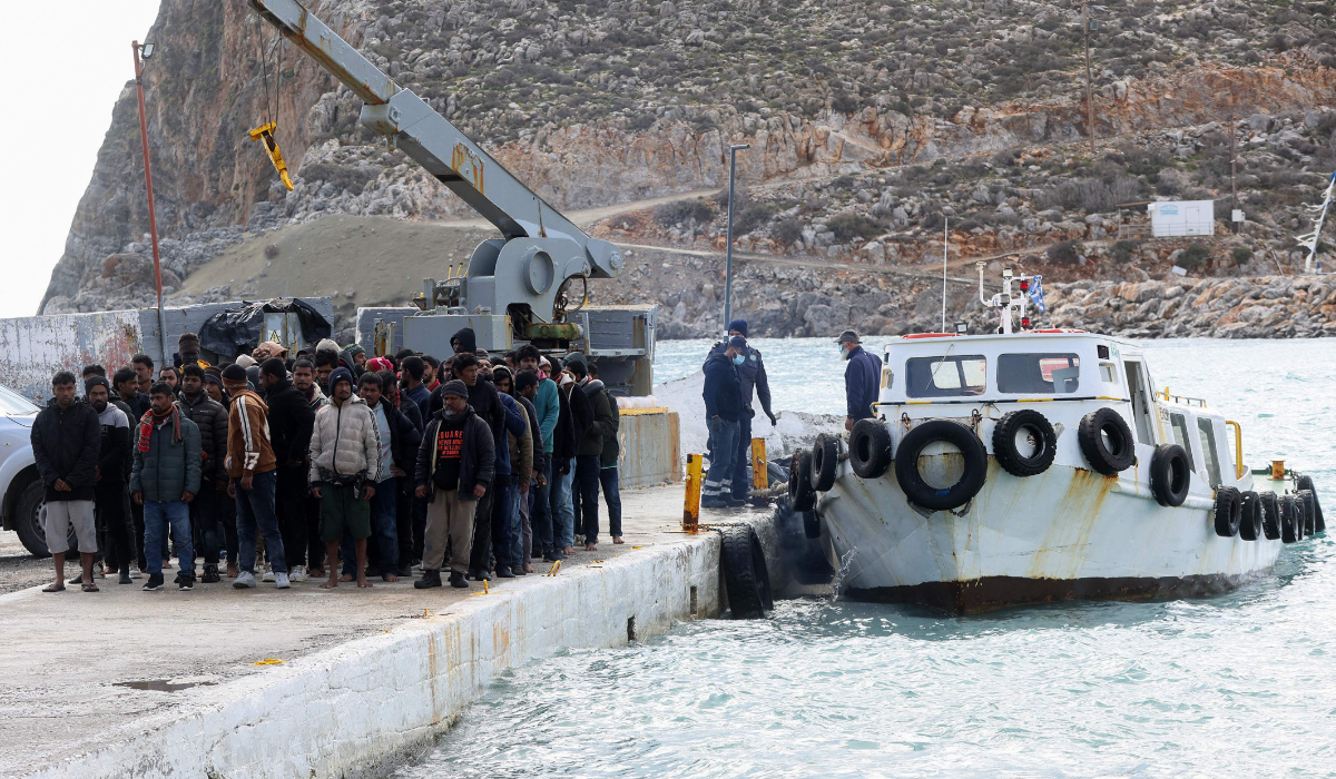 Migrants disembark from a boat at the port of Kali Limenes, in Heraklion, southern Crete, on February 21, 2026. (AFP)
