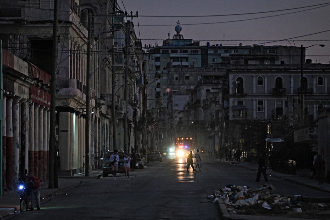People walk down a street during a blackout in Havana, Cuba. (AFP)