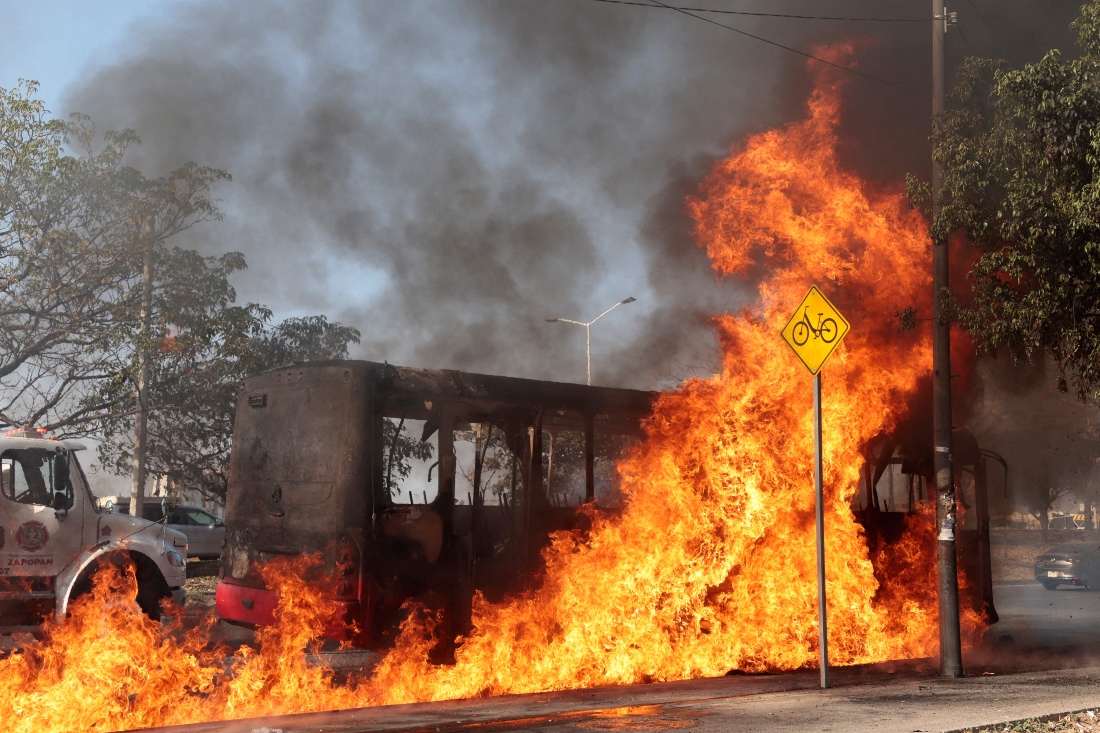 A bus burns at one of the main avenues after it was set on fire by organized crime groups in Zapopan, Mexico. (AFP)