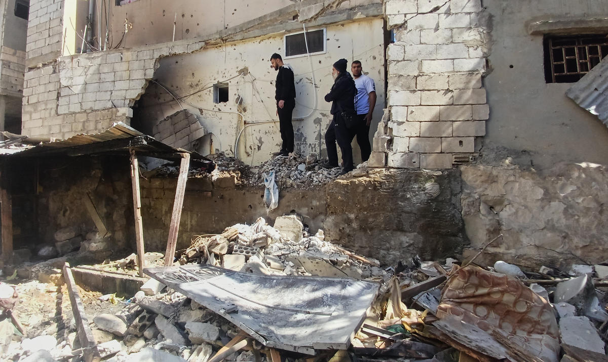 People check the damage at the site where two Hamas members were killed on Friday by an Israeli strike at Ein el-Hilweh Palestinian refugee camp, in the southern port city of Sidon, Lebanon, Saturday, Feb. 21, 2026. (AP)