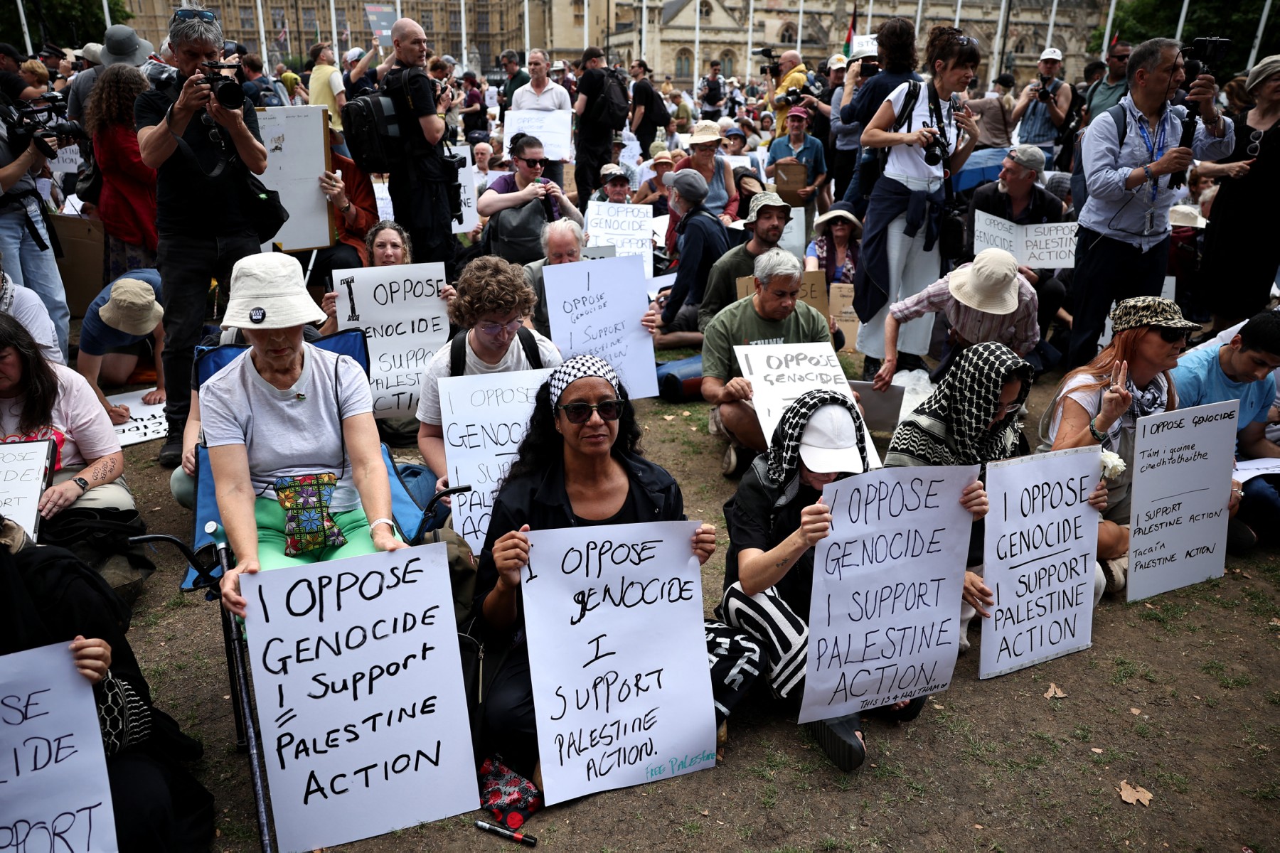 Protesters hold placards at a "Lift The Ban" demonstration in support of the proscribed group Palestine Action in Parliament Square, central London, on August 9, 2025. (File/AFP)