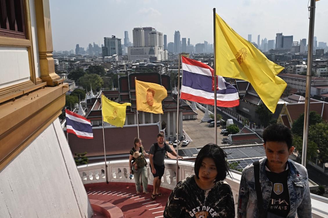 Thai flags are seen among yellow religious flags as visitors climb the stairs at Wat Saket Buddhist temple the day after the general election, in Bangkok on February 9, 2026. (FILE/AFP)