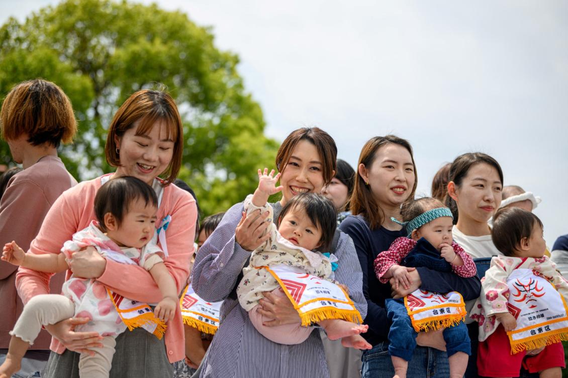 The Japanese government is striving to build a stronger economy to reduce the economic burden of childcare for working families. (AFP)