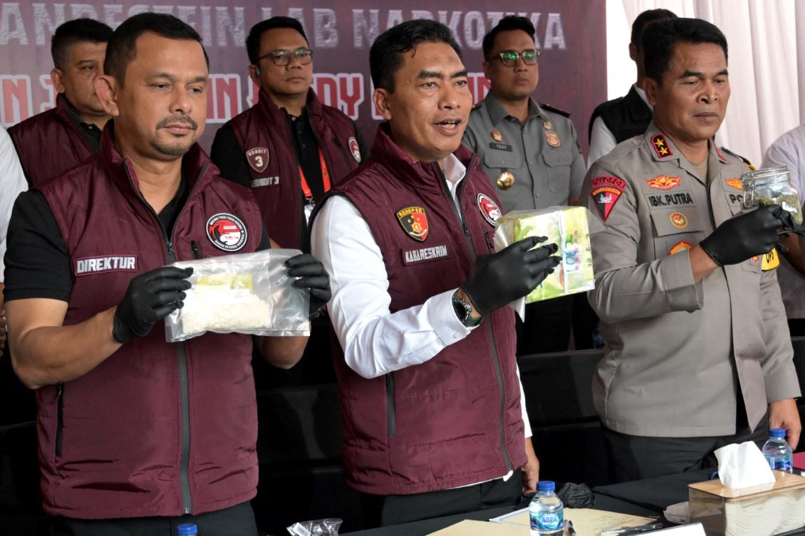 Indonesia's criminal investigation agency, with seized drugs following a police raid on a suspected drug lab during a press conference in Tibubeneng Village, Badung Regency on Indonesia's Bali island on May 13, 2024. (File/AFP)