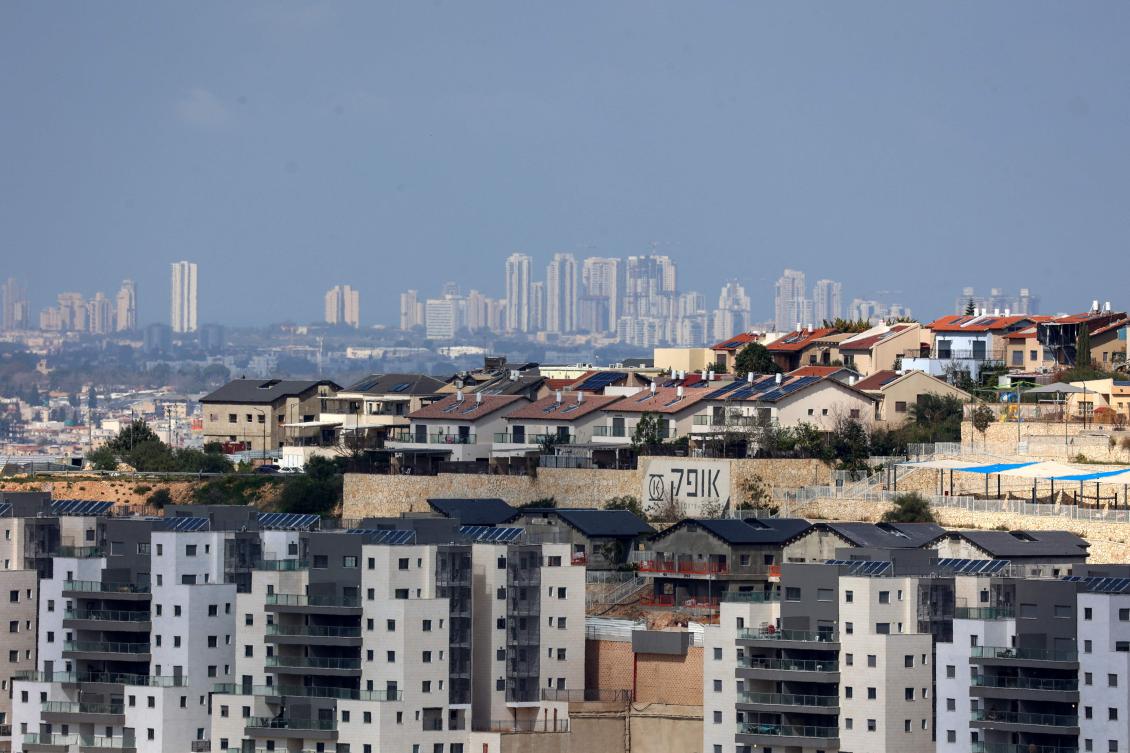 The Israeli settlement of Tzufim in the north of Qalqilya city in the occupied West Bank is pictured against the backdrop of Israeli city of Netanya. (AFP)