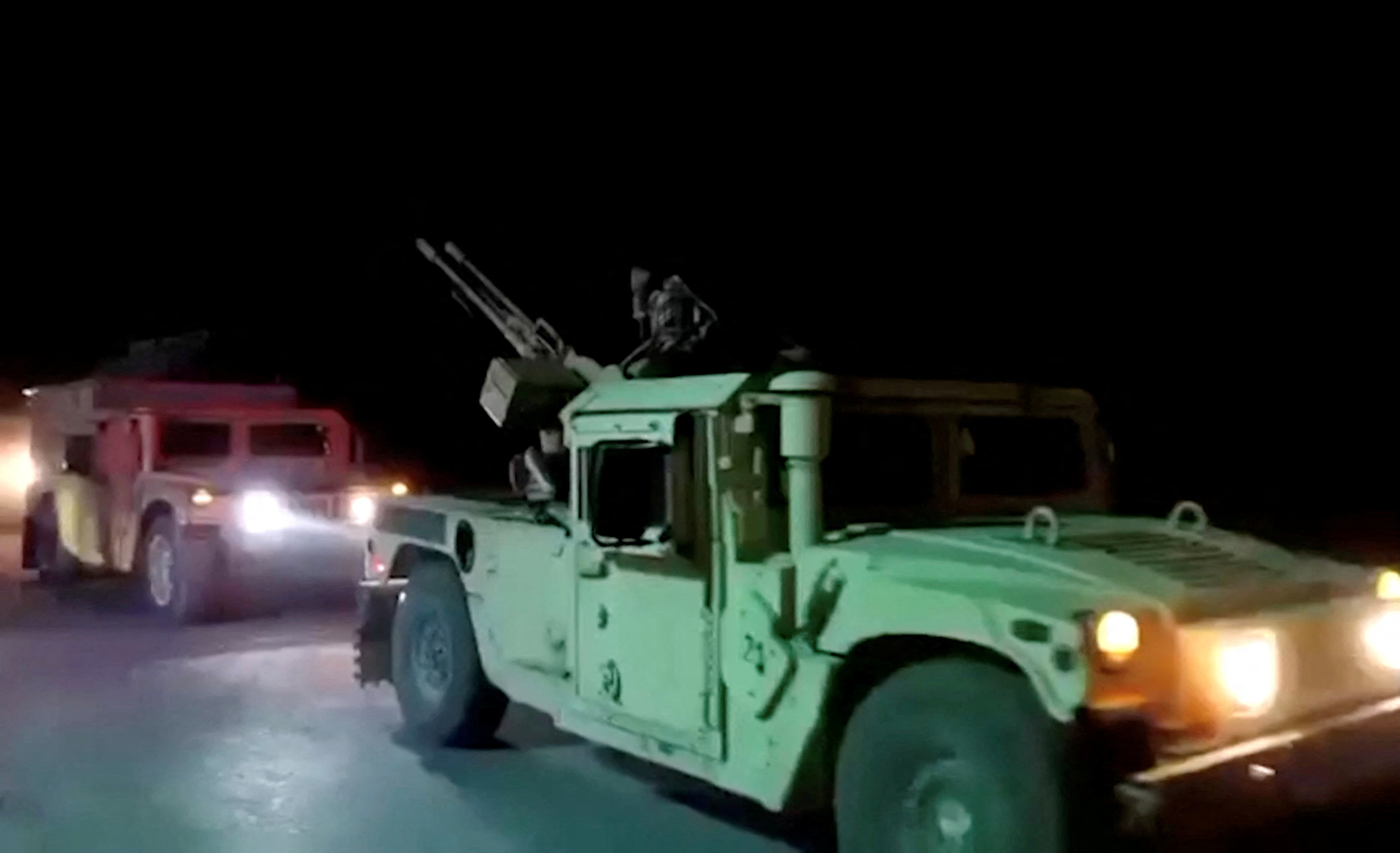 Military vehicles move on a road in a location given as Nangarhar, Afghanistan, in this screengrab from a handout video released on February 26, 2026. (Afghanistan’s Ministry of Defense/Reuters)