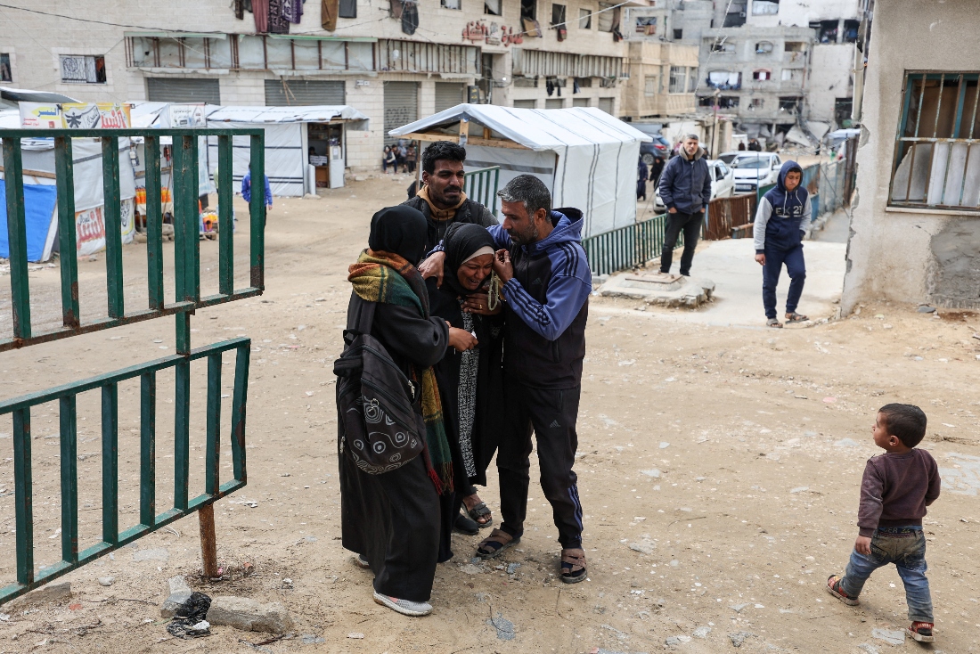 A child walks next to mourners during the funeral of two Palestinians killed by an Israeli strike on Thursday, according to medics, at Shifa hospital in Gaza City. (Reuters)