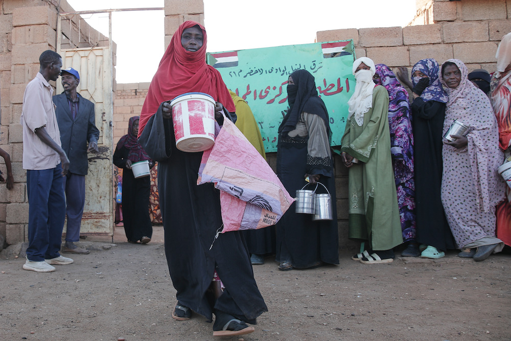 A woman carries food as she leaves a charity kitchen in Khartoum, Sudan, Wednesday, Jan. 21, 2026. (AP/File Photo)