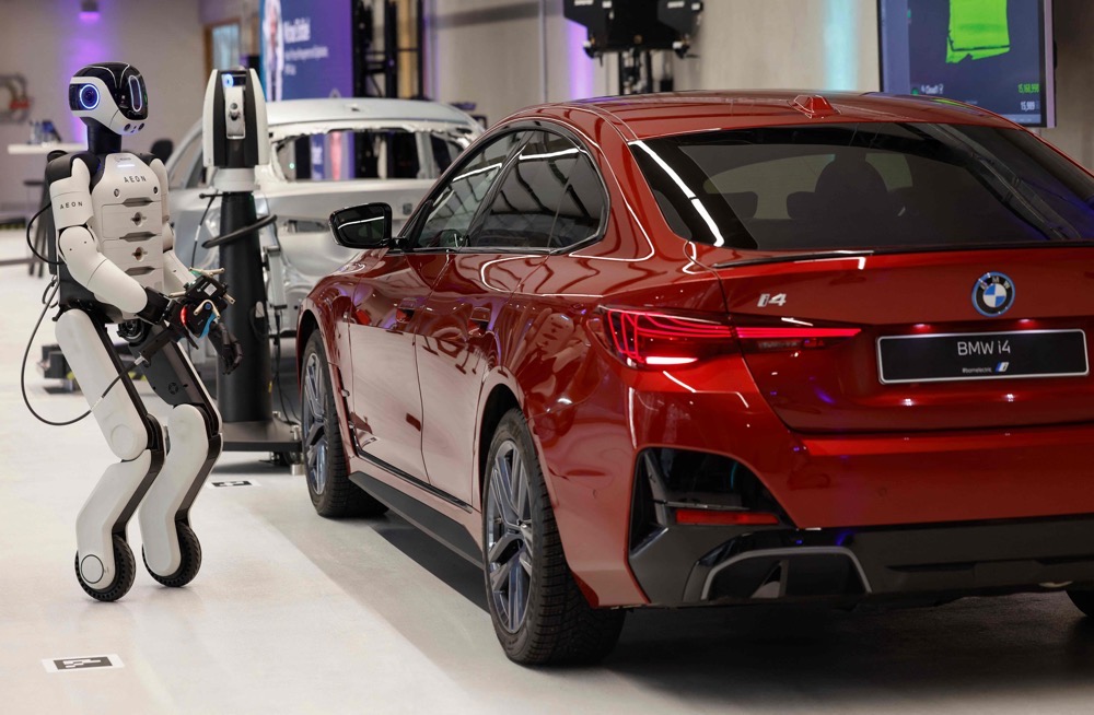 A robotic works on a car with a laser scanner, as it is presented by BMW is presented by BMW, at their BMW Group Talent Campus in Munich, Bavaria, southern Germany. (AFP)
