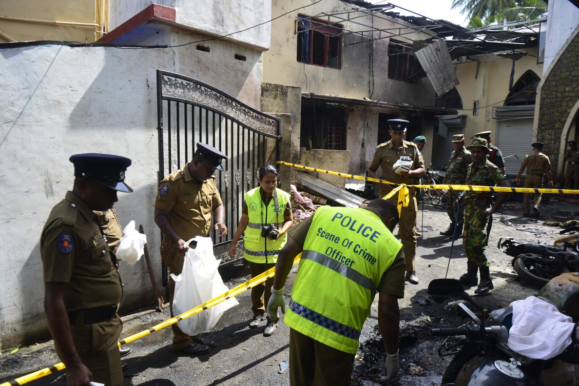 Sri Lankan security personnel and police investigators look through debris outside Zion Church following an explosion in Batticaloa in eastern Sri Lanka on April 21, 2019. Nine suicide bombers carried out the coordinated Easter attacks that killed 279 people. (AFP file photo)
