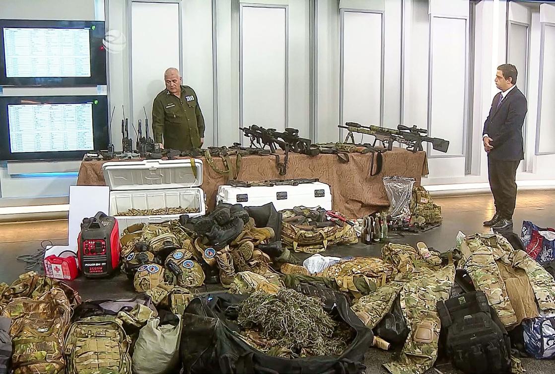 Above, seized weapons, radios and military elements that according to the Cuban official television was used during the confrontation with a vessel arriving from the US on Feb. 25, 2026. (Cuban TV/AFP)
