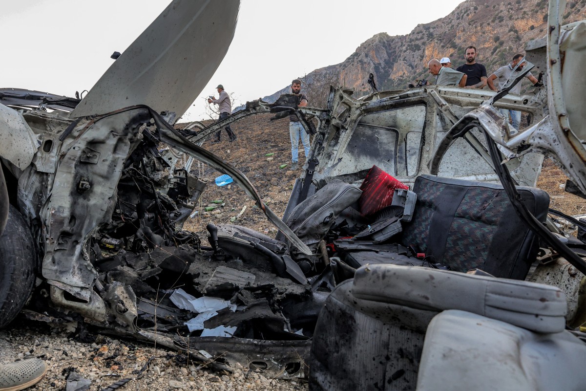 First responders and security forces gather at the site of an earlier Israeli strike on a vehicle on the Khardali road in south Lebanon’s Marjayoun area on Sept. 20, 2025. (AFP file photo)