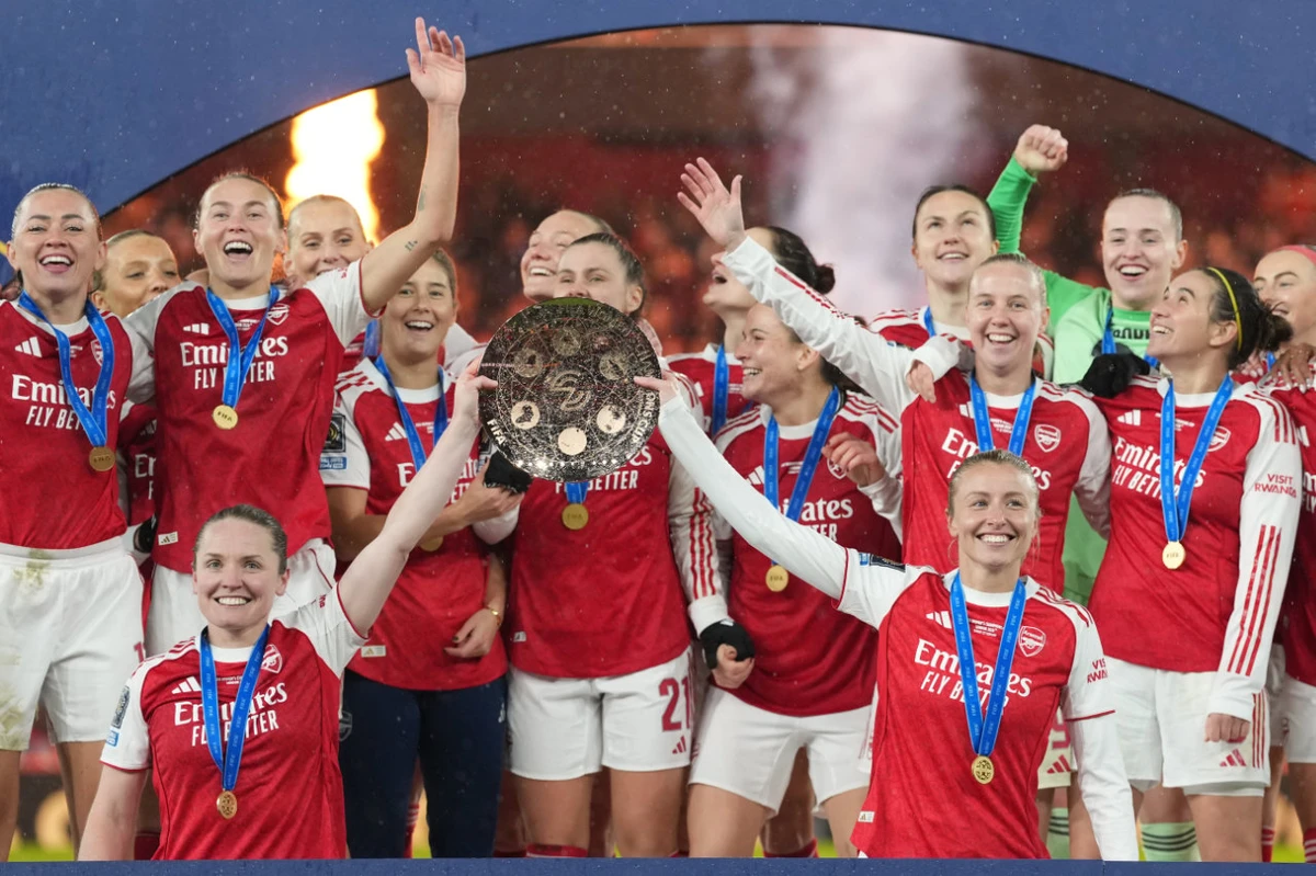 Arsenal’s team captains Kin Little, left, and Leah Williamson, right, lift the trophy after winning the Women's Champions Cup final football match between Arsenal FC and SC Corinthians in London Sunday. (AP)