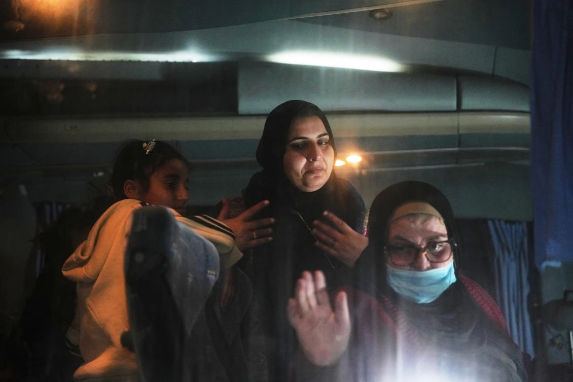 Rotana Al-Regeb, center, and her mother Huda Abu Abed, a heart patient, get off a bus after being were allowed into Gaza from Egypt on early Feb. 3, 2026. (AP)