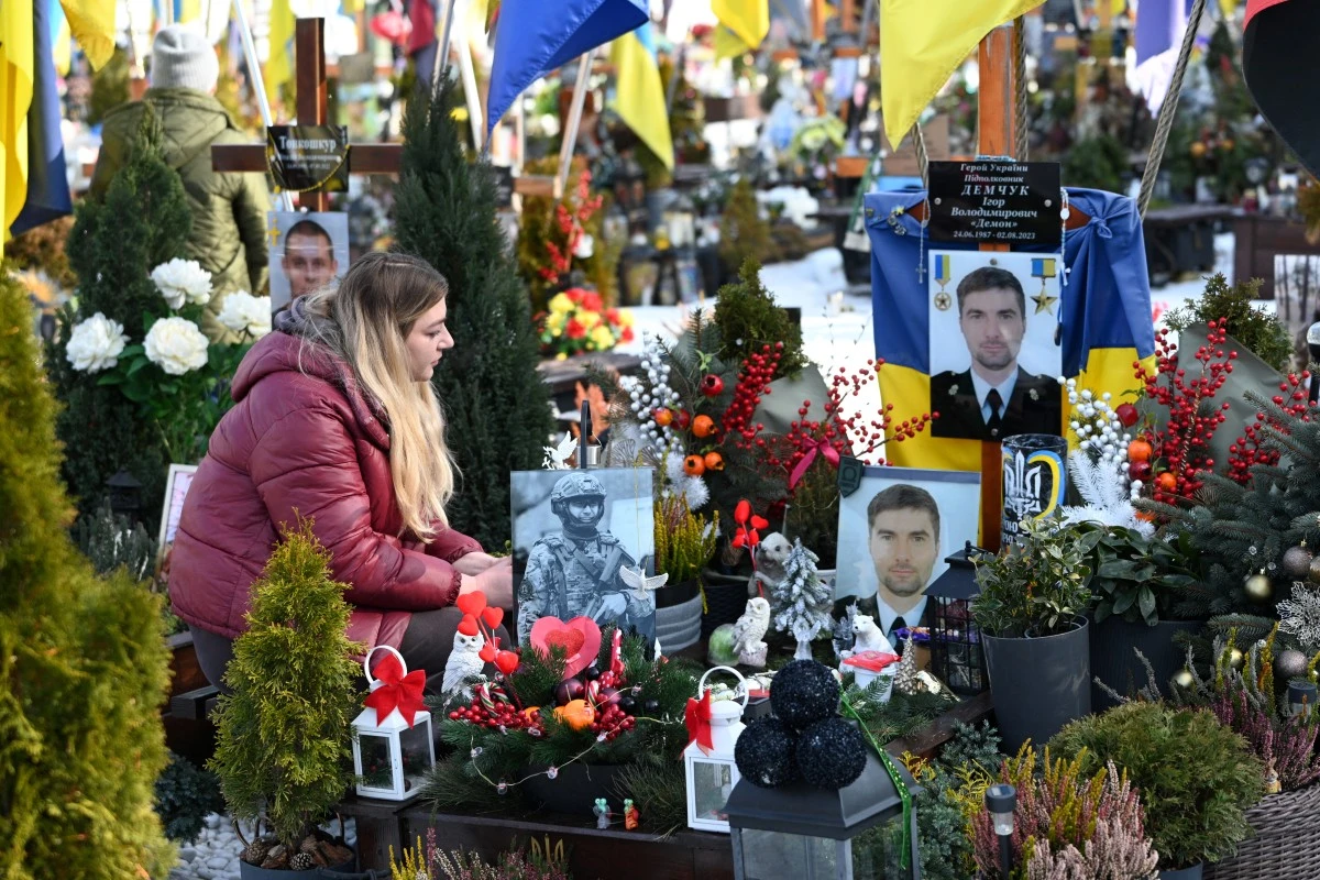Widow of a fallen Ukrainian soldier visits his grave on Valentine's Day at the Lychakiv Military Cemetery in Lviv, Ukraine. (AFP)
