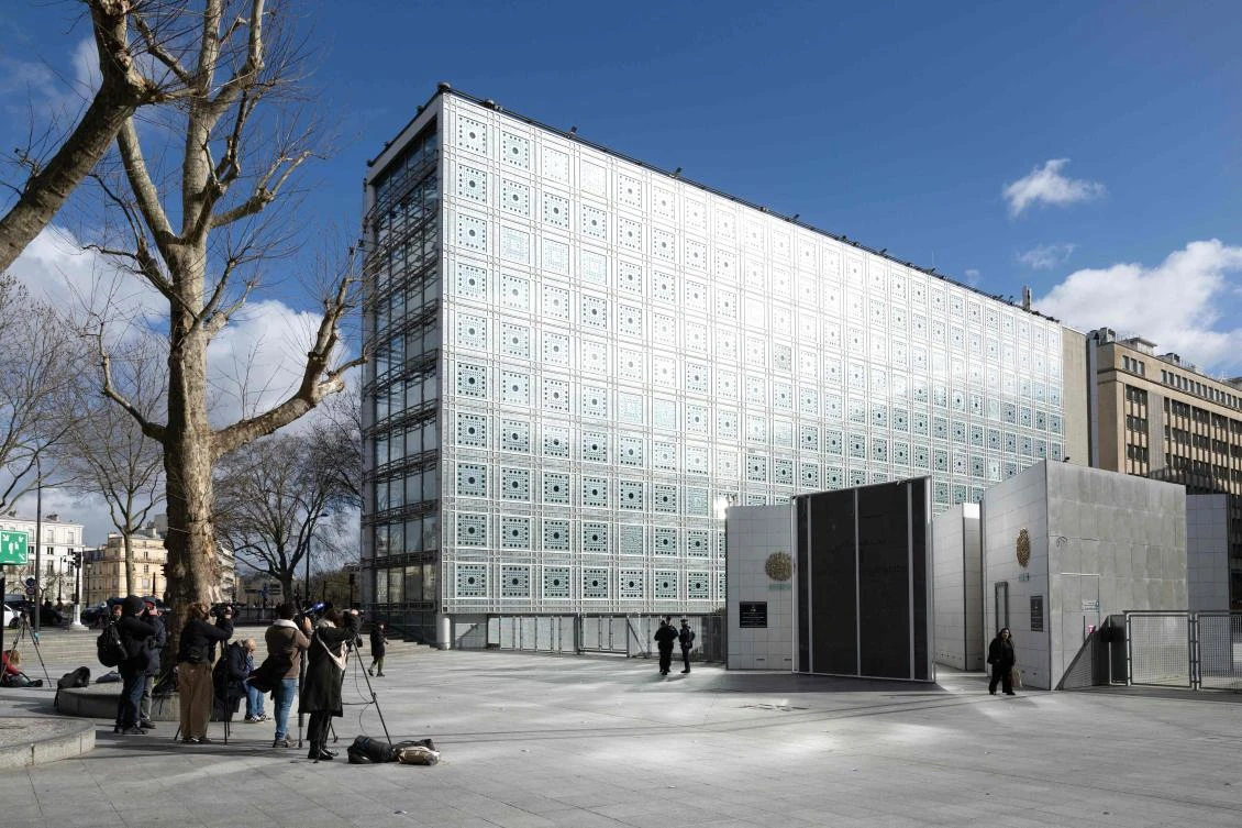 Journalists stand in front of the Institut du Monde Arabe during a search as part of investigations entrusted to the National Anti-Fraud Office on the Epstein case linked to its president Jack Lang, on February 16, 2026. (AFP)