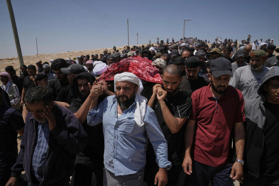Mourners carry the body of Palestinian activist Awdah Hathaleen during his funeral in the West Bank Bedouin village of Umm Al-Khair, Aug. 7, 2025. (AP)