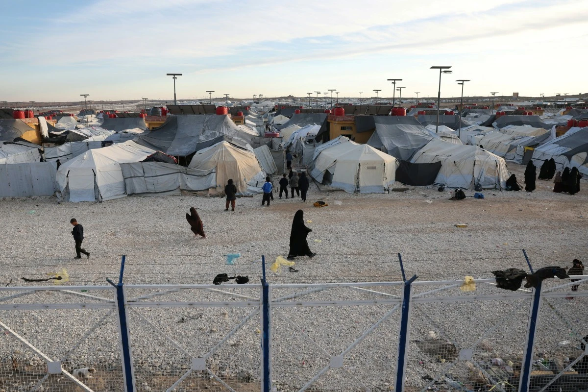 Children and women, relatives of suspected Islamic State jihadists, walk inside Al-Hol camp in the desert region of Syria's northeastern Hasakeh province on January 21, 2026. (File/AFP)
