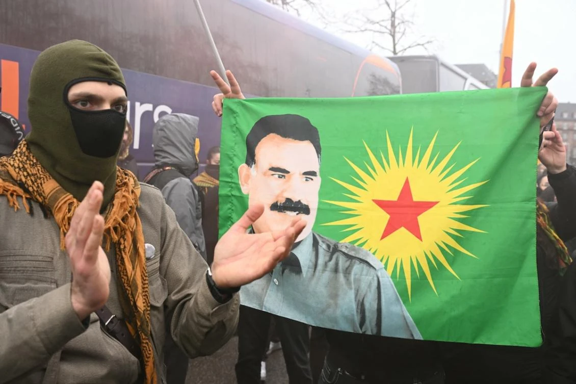 Protestors hold a flag bearing a portrait of jailed leader of the Kurdistan Workers' Party (PKK) Abdullah Ocalan during a demonstration of Kurdish people from all around Europe to mark the 27th anniversary of his arrest and to demand his liberation, in Strasbourg, Eastern France, on February 14, 2026. (FILE/AFP)