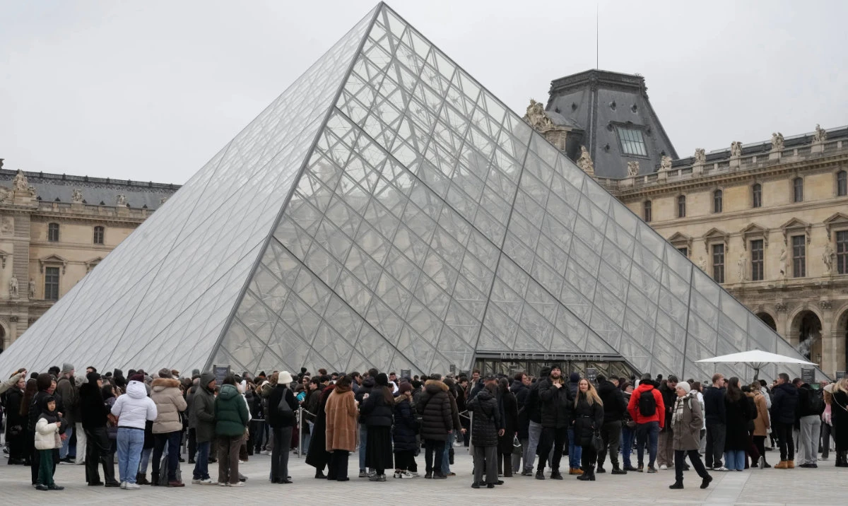 People queue outside the Louvre museum, in Paris, France, Friday, Feb. 13, 2026. (AP)