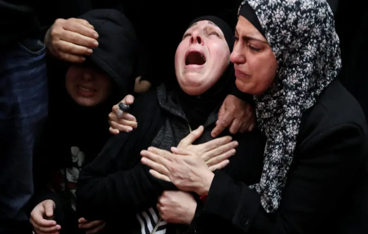 The mother of Nasrallah Abu Siyam, 19, grieves at his funeral on Thursday. His family have demanded accountability, amid mounting scrutiny over a surge in settler violence and a lack of prosecutions. (Reuters)