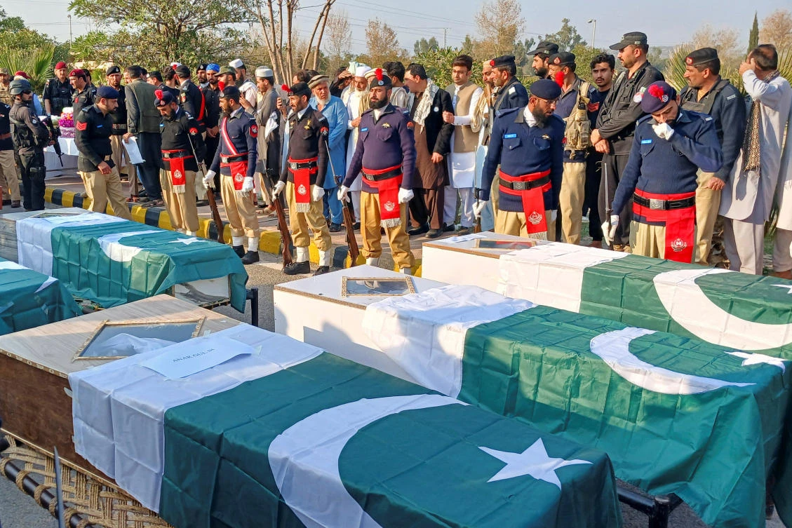 Police and residents gather beside the flag-draped coffins of police officers, who were killed in a terrorist attack, Kohat, Khyber Pakhtunkhwa, Pakistan, Feb. 24, 2026. (Reuters)