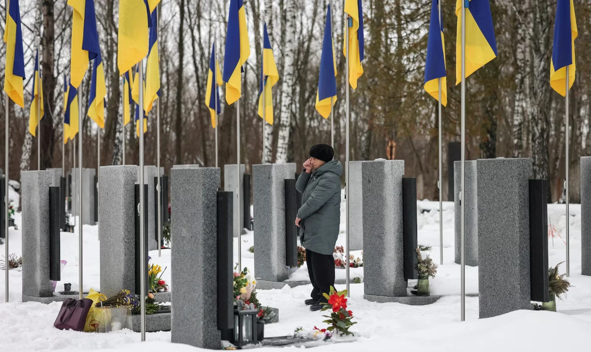 A woman reacts as she stands in front of a grave at a local cemetery, as she pays tribute to the victims of the Russian attack on Ukraine, on the day marking the fourth anniversary of the full-scale Russian invasion, in Chernihiv, Ukraine February 24, 2026. (Reuters)