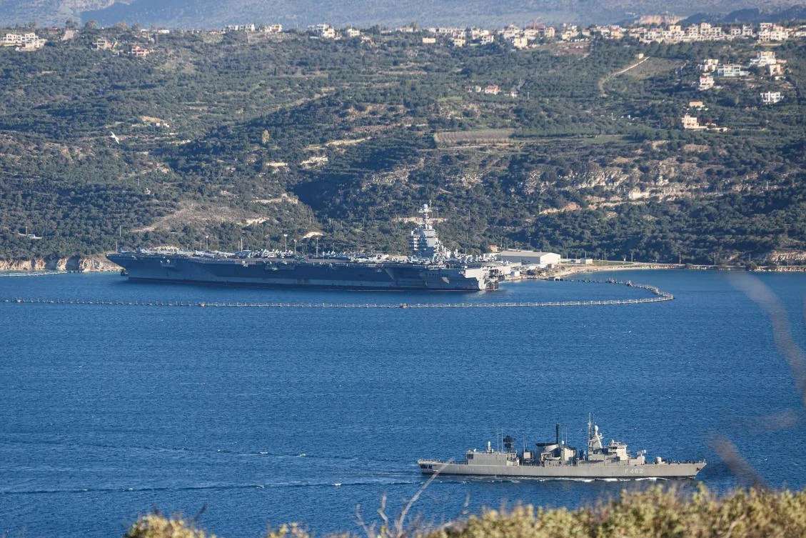 US aircraft carrier USS Gerald Ford, left, docked at Souda Bay in the Greek Mediterranean island of Crete, on Feb. 24, 2026. The world's largest vessel is on its way to the Middle East to join 13 more warships stationed in the region. (AFP)
