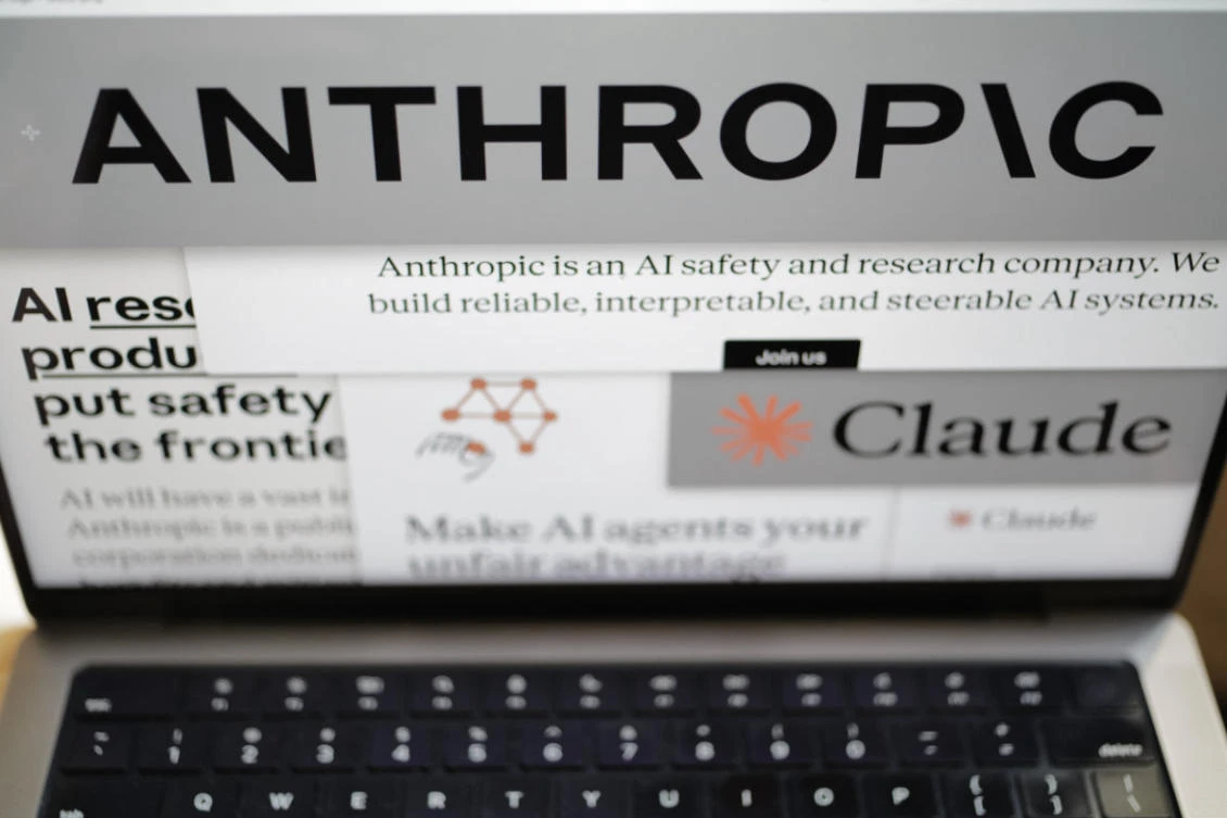 Pages from the Anthropic website and the company's logos are displayed on a computer screen in New York on Feb. 26, 2026. (AP Photo/Patrick Sison)