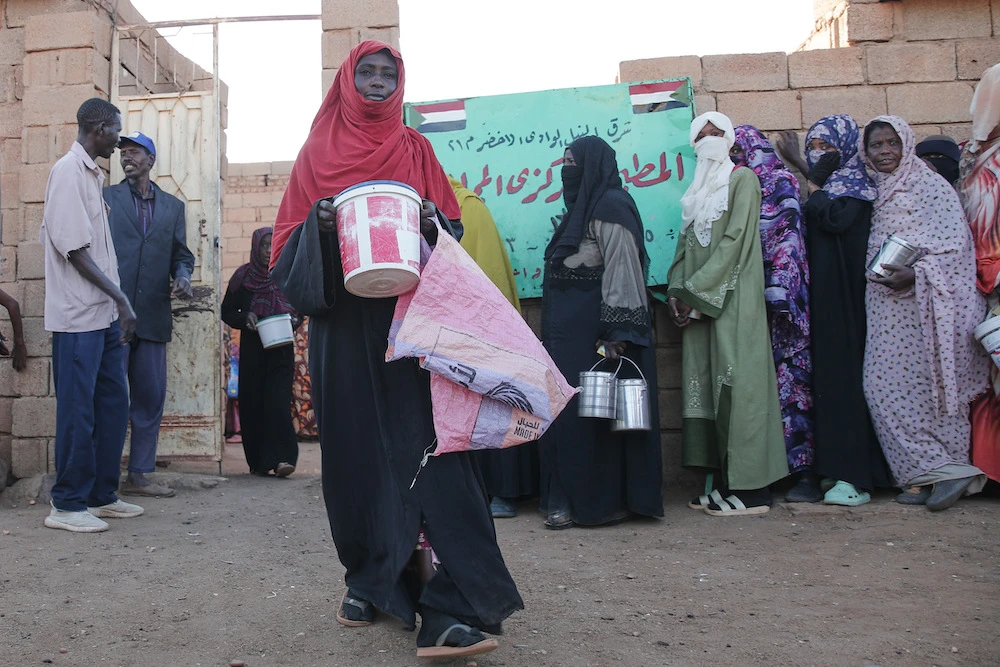 A woman carries food as she leaves a charity kitchen in Khartoum, Sudan, Wednesday, Jan. 21, 2026. (AP/File Photo)