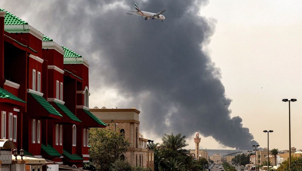 An Emirates aircraft prepares to land amid an ongoing fire near Dubai International Airport, Mar. 16, 2026. (AFP)