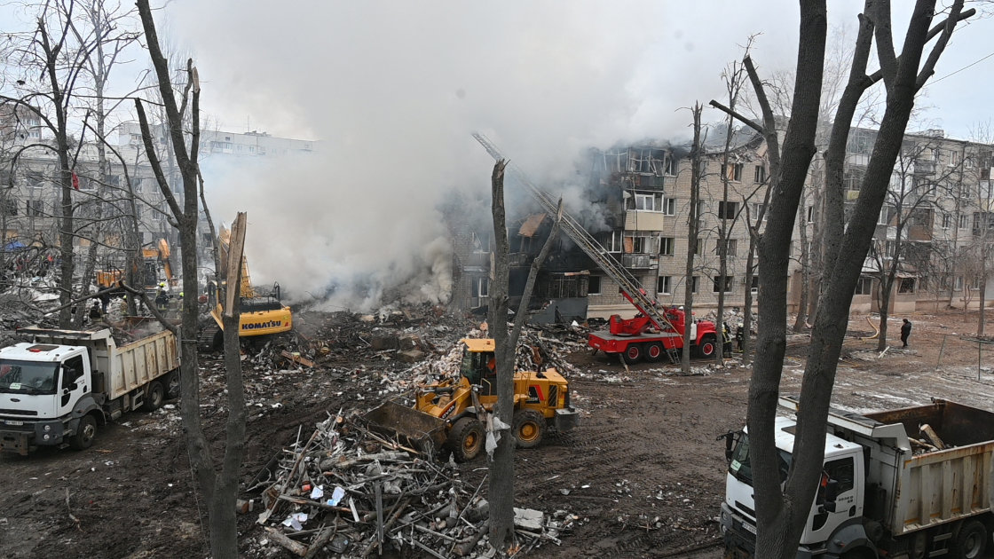 Rescuers work at the bottom of a five-story residential building which was hit by a ballistic missile in Kharkiv. (AFP)
