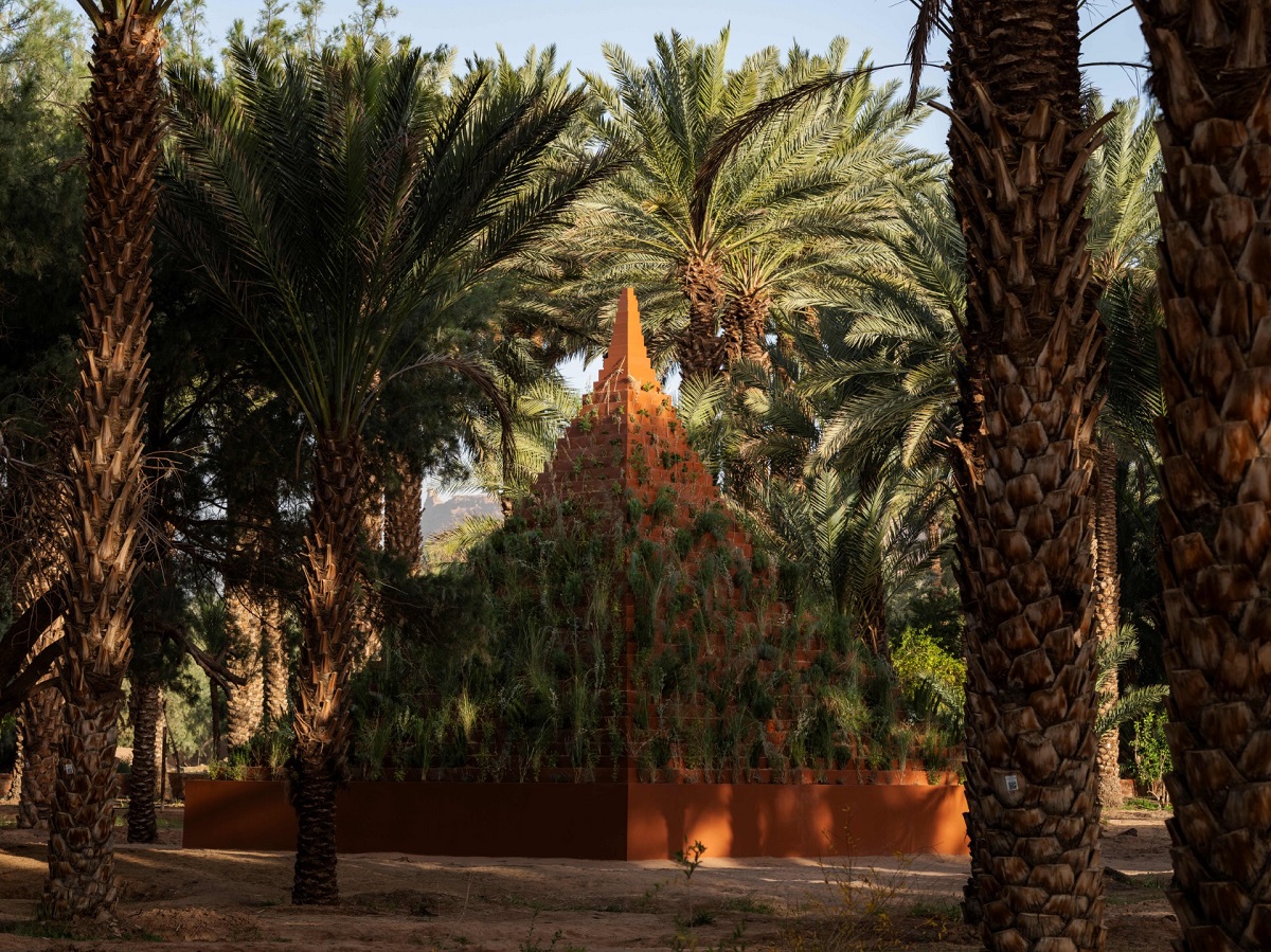 The pyramid structure is teeming with indigenous plants, forming layered patterns that echo the surrounding desert landscape. (Supplied)