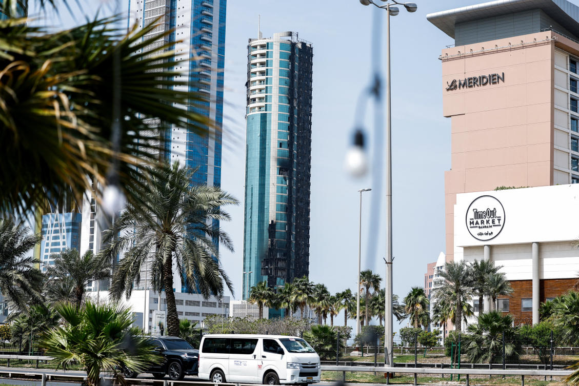 Above, vehicles drive past a building that was damaged by an Iranian drone attack in Seef, Manama, Bahrain on March 1, 2026. The UK has urged its =citizens in Bahrain, Kuwait, Qatar and the United Arab Emirates to “shelter in place” amid the escalating conflict. (Reuters)