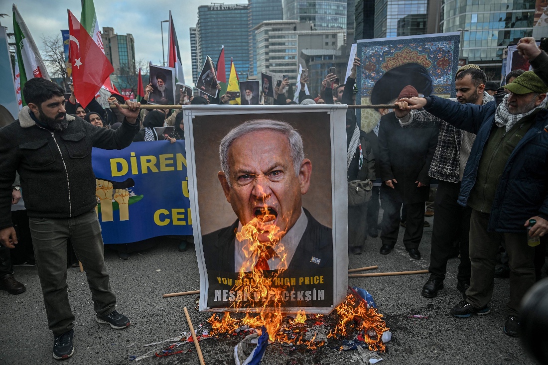 Protestors set fire to an image depicting Israeli Prime Minister Benjamin Netanyahu at a protest against the US and Israel attack of Iran in front of Israel Consulate in Istanbul, Turkiye.