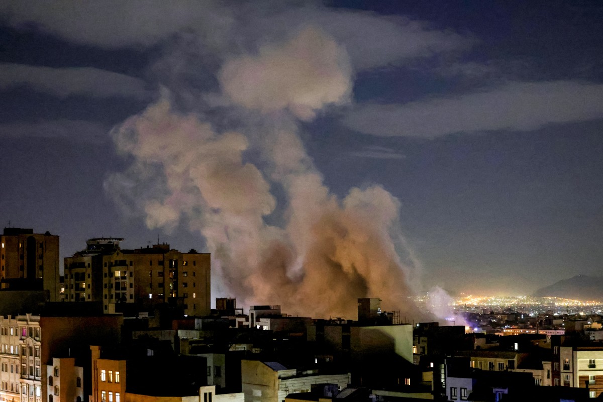 A smoke plume rises following a missile strike on a building in Tehran, Iran. (AFP)