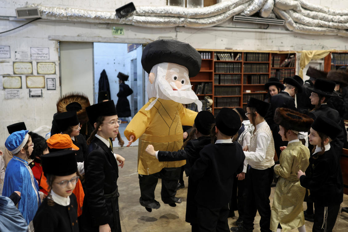 A boy wearing a costume stands among other Ultra-Orthodox Jewish boys in a bomb shelter during the Jewish holiday of Purim in Bnei Brak, Israel. (Reuters)