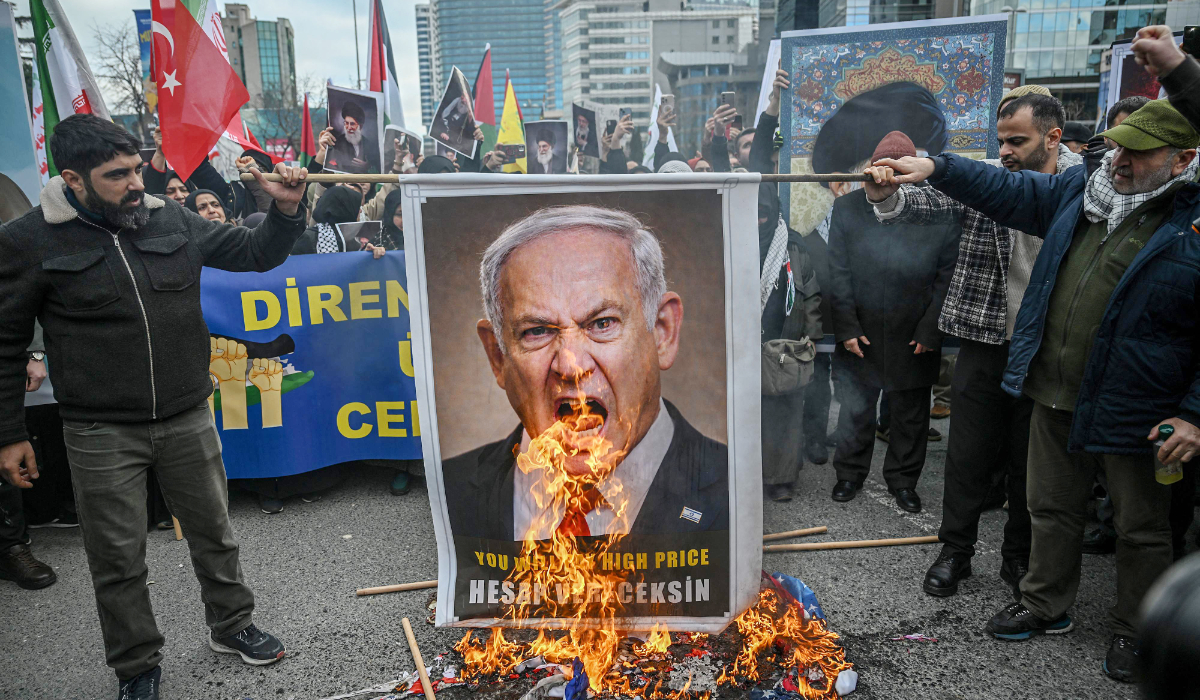 Protestors set fire to an image depicting Israeli Prime Minister Benjamin Netanyahu during as they gather to protest against the US and Israel attack of Iran and the killing of the Supreme leader in front of Israel Consulate in Istanbul on March 1, 2026. (AFP)