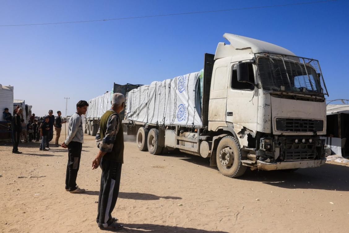 Palestinians look on as trucks carrying humanitarian aid arrive in Khan Yunis in the southern Gaza Strip on February 1, 2026. (File/AFP)