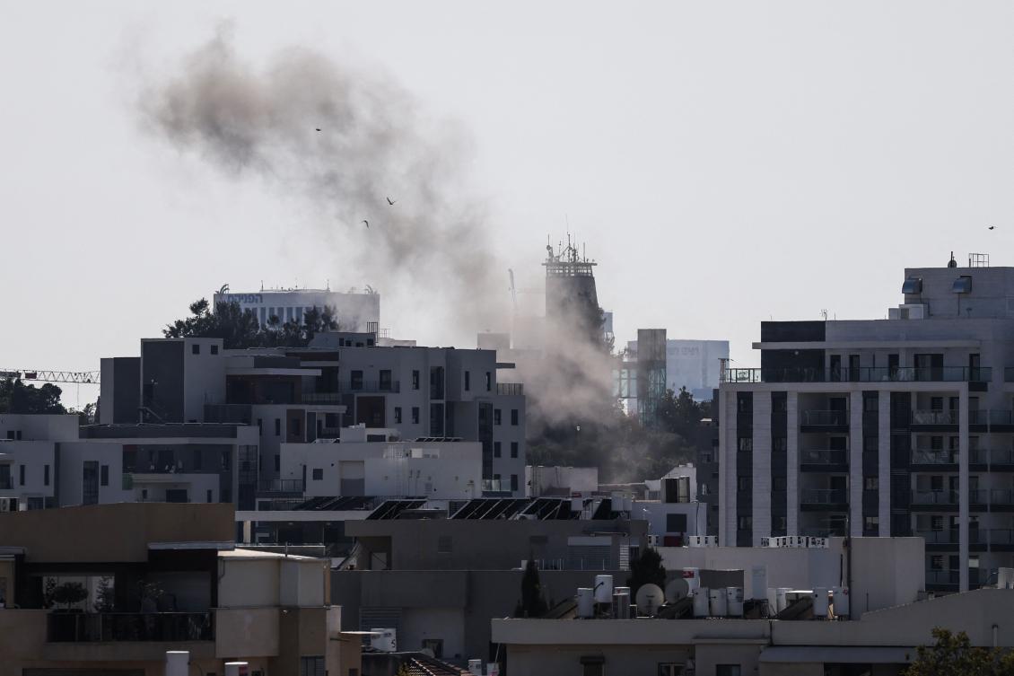 Smoke rises from behind buildings after a projectile struck the area in Tel Aviv on Mar. 3, 2026. (AFP)