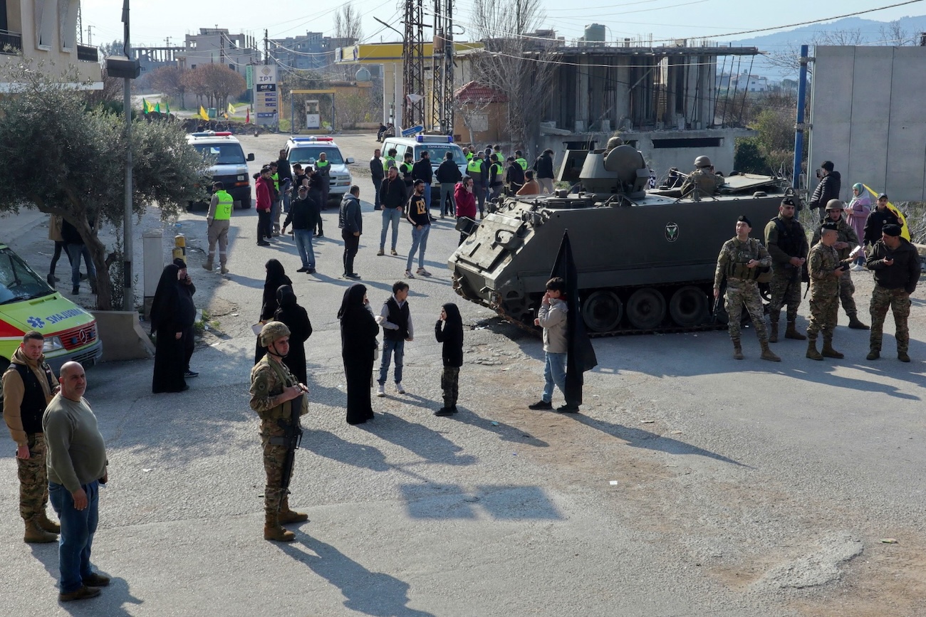Residents of the southern Lebanese village of Kfarkila gather at a Lebanese army checkpoint in Burj Al-Muluk on the outskirts of their village. (File/AFP)