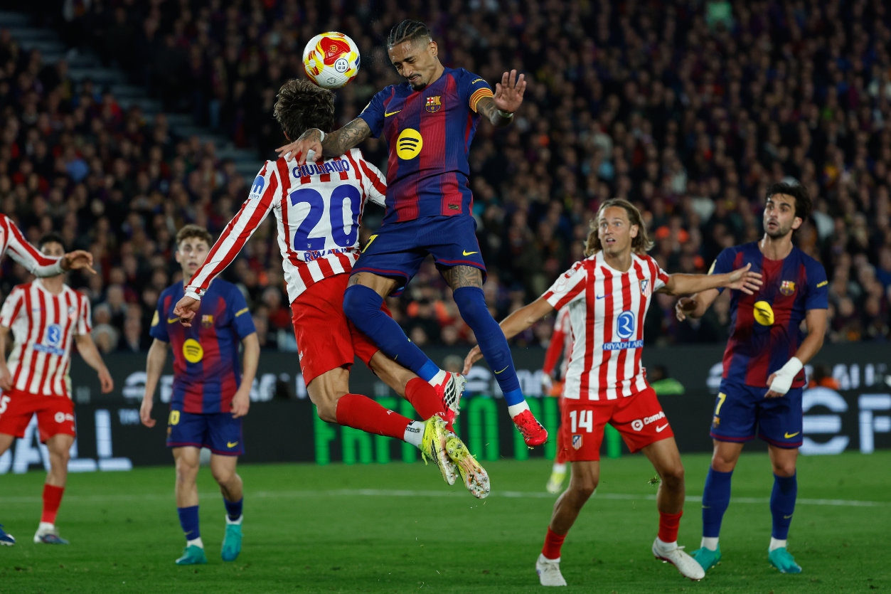 Atletico Madrid's Giuliano Simeone, left, and Barcelona's Raphinha challenge for the ball during the Copa del Rey semifinal second leg soccer match between Barcelona and Atletico Madrid in Barcelona, Spain, Tuesday, March 3, 2026. (AP)
